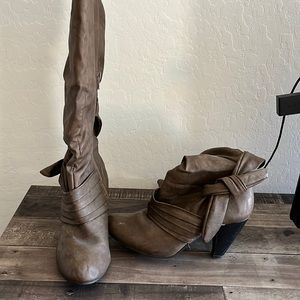 Brown faux leather knee high boots.